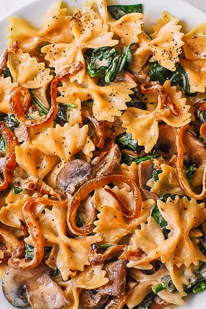 CREAMY BOW TIE PASTA WITH SPINACH MUSHROOMS, AND CARAMELIZED ONIONS
